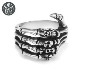 Bague pirate main : Anneau en forme de main squelettique avec doigts à tête de mort